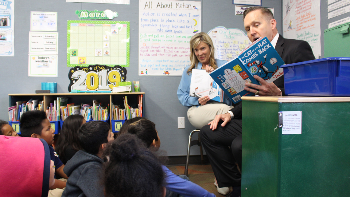 Jeffrey Martin reads to students during a recent visit to an elementary school.